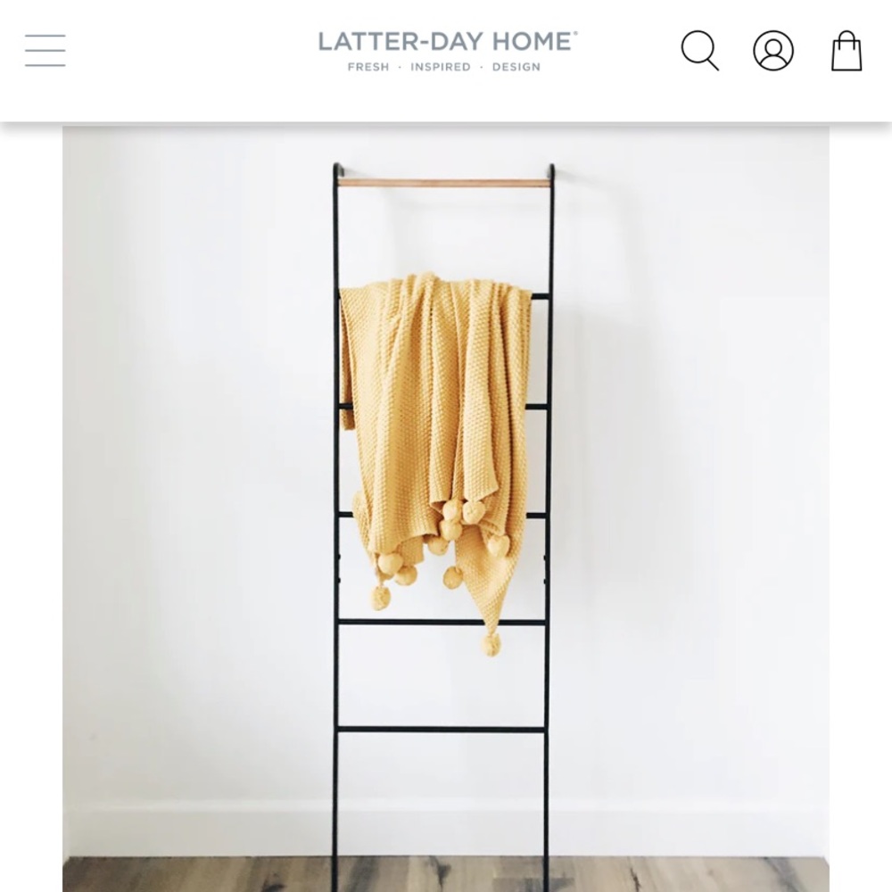 yellow throw with pom poms